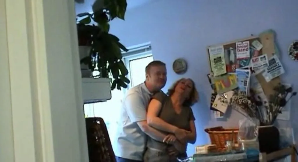 Andy and Sheila King embrace in their kitchen in Exhibit A 2007