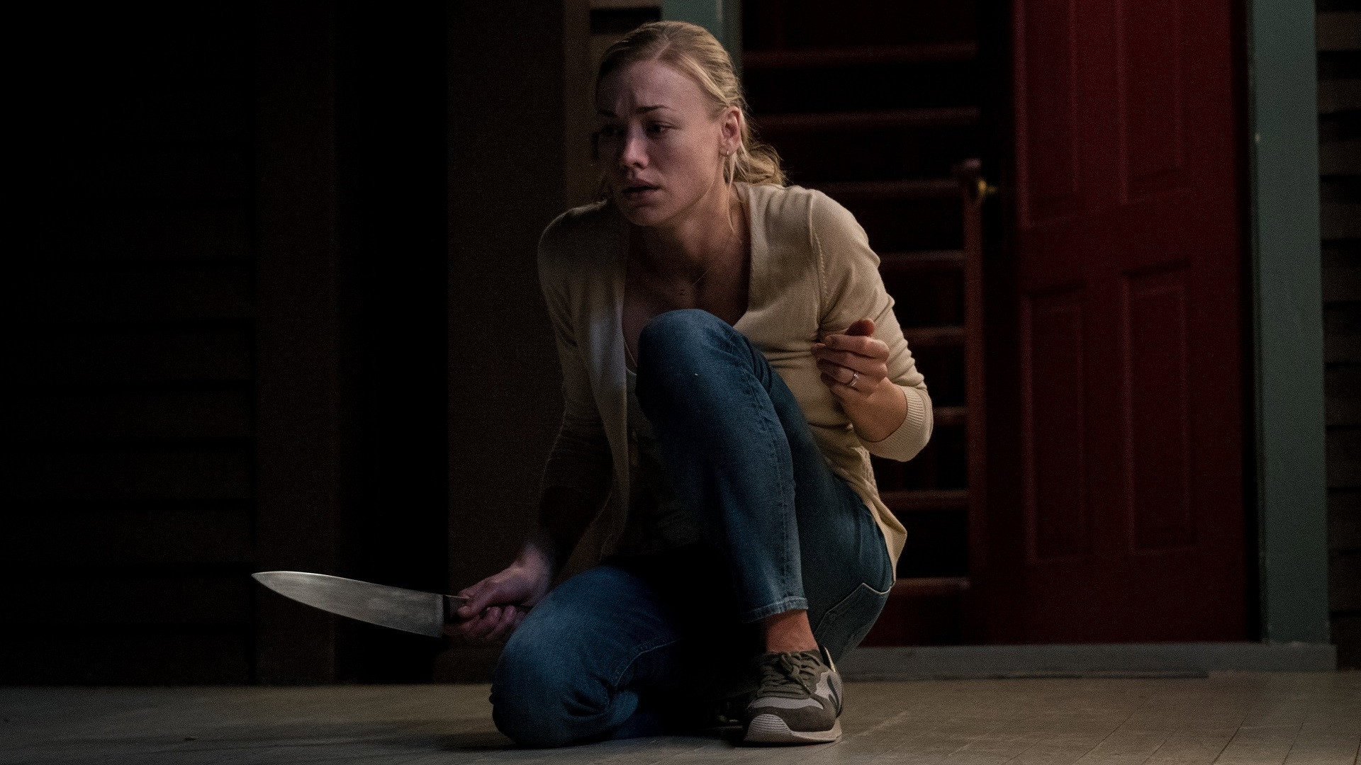Laura armed with a kitchen knife inside the lake house