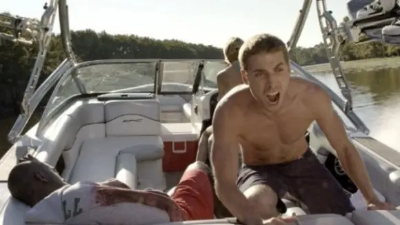 Nick helps an injured Malik after a shark attack in Shark Night 2011