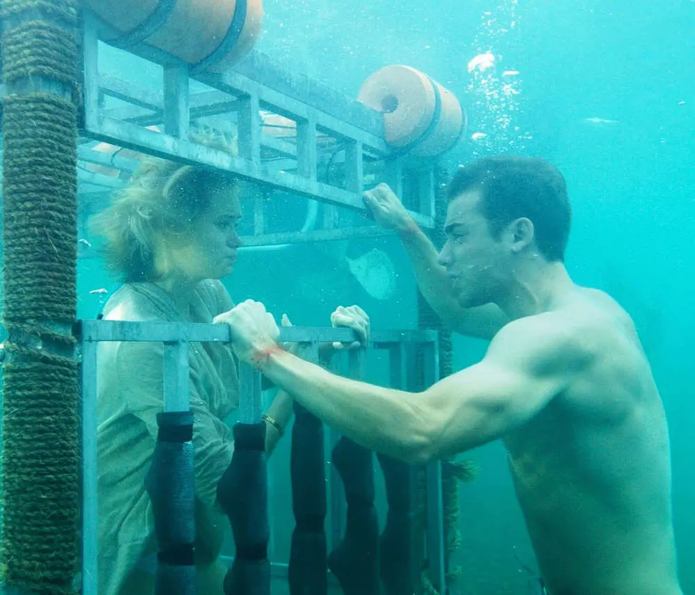Sara trapped inside the underwater shark cage during the climax of Shark Night 2011