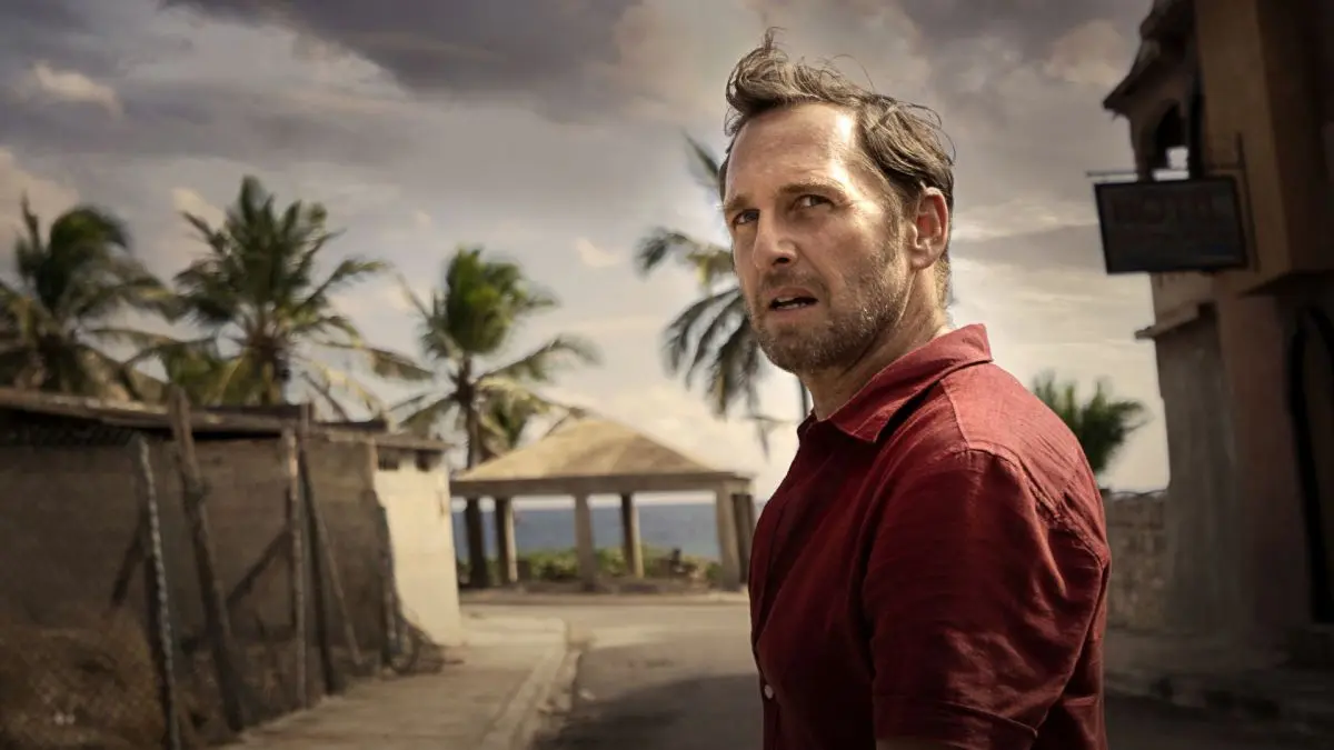 Josh Lucas as Paul Sturges in the ruined coastal town in The Black Demon 2023