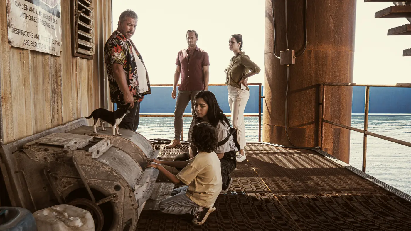 Paul and his family stranded with Chato and Toro on the oil rig in The Black Demon 2023