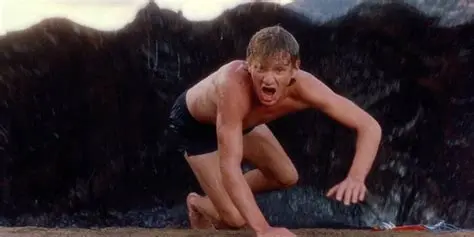 Randy on shore as the creature rises behind him