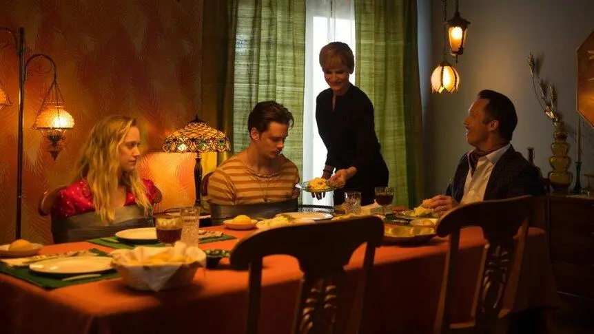 Mickey and Jules held at the dinner table with George and Gloria in Villains