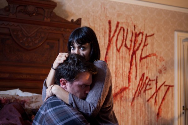 Felix and Zee beneath the blood-written warning