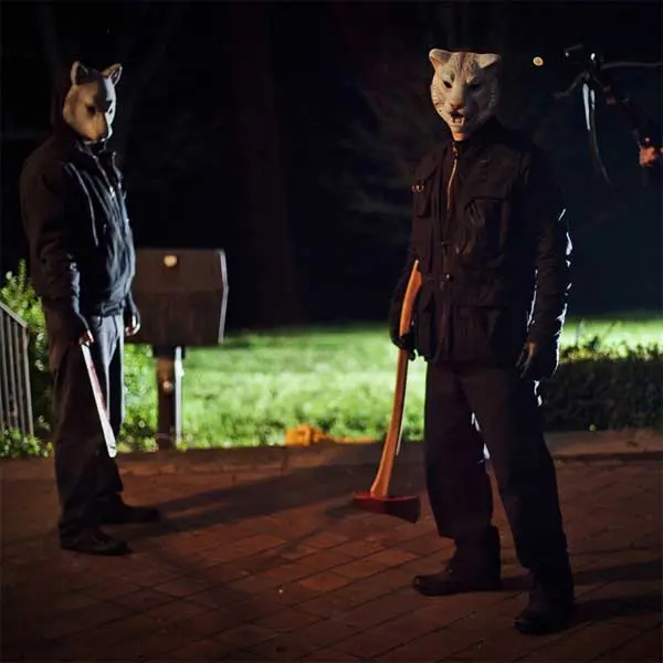 Two of the animal-masked killers outside the house